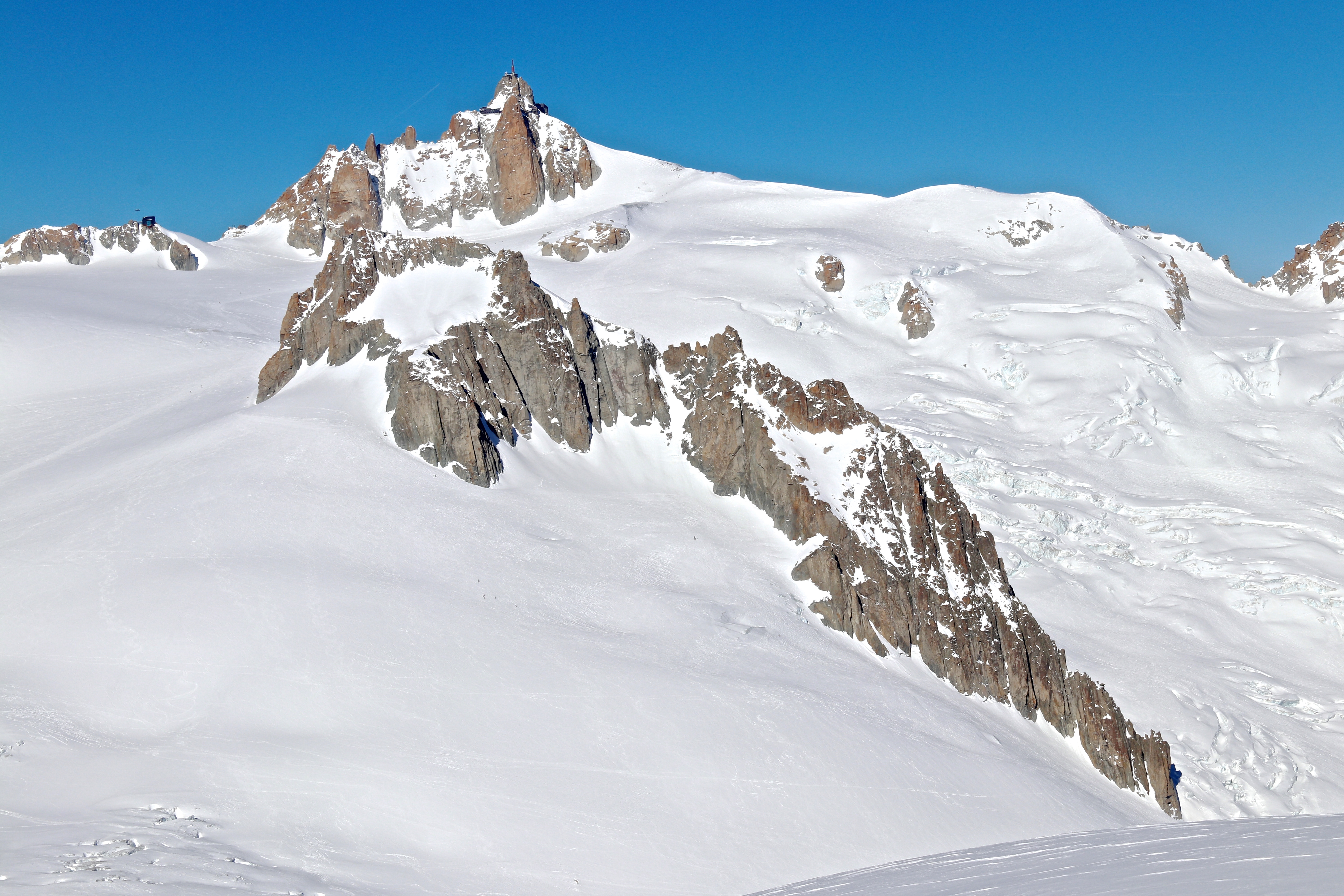 Nunataket Gros Rognon (3.541 mot) deler Clacier du Géant og Vallée Blanche. Aiguille du Midi (3.842 moh) bak.